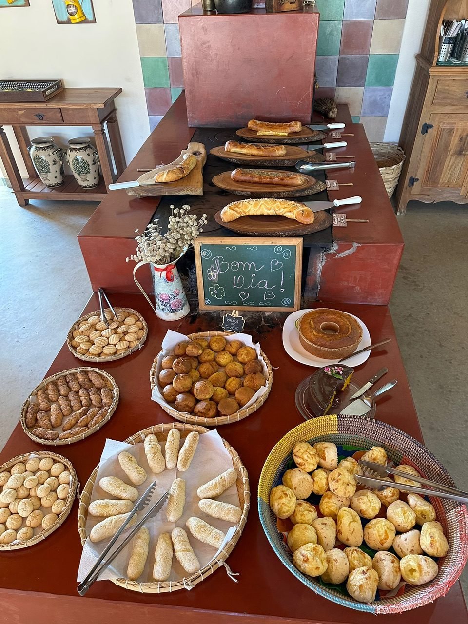 Café da manhã da Pousada Vale dos Canteiros com pães, bolos, quitandas e pão de queijo.